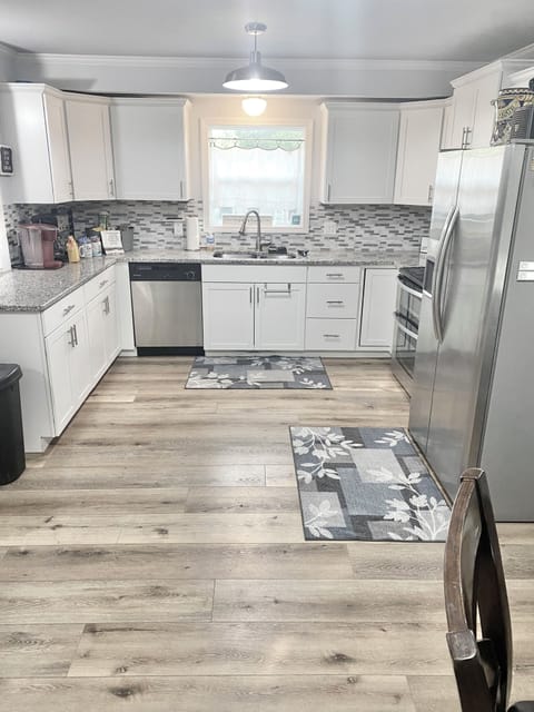 Kitchen has lots of cabinets and a pantry