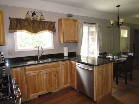 Fully equipped kitchen featuring rustic maple cabinets and granite counter tops.