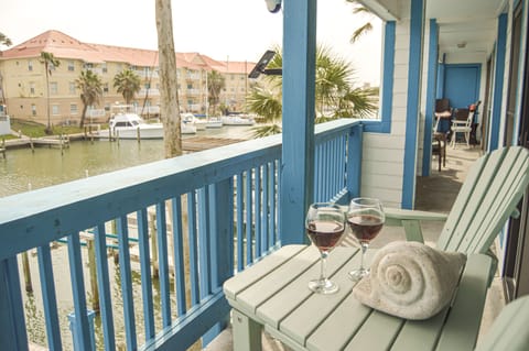 Sip your evening wine on your private balcony while watching boats drift by the marina below.