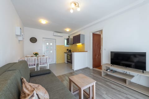 Apartment, Sea View | Living area | 100-cm flat-screen TV with digital channels