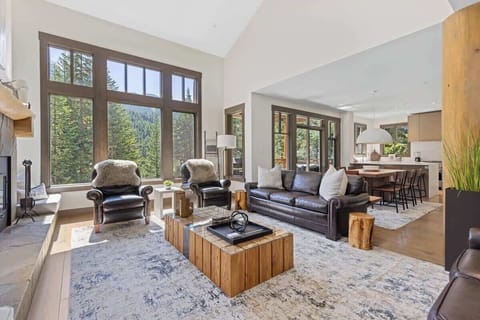 - Bright lounge with panoramic forest scenery  
- Cozy mountain cabin filled with natural light and warmth  
- Open living area blending luxury and nature perfectly  