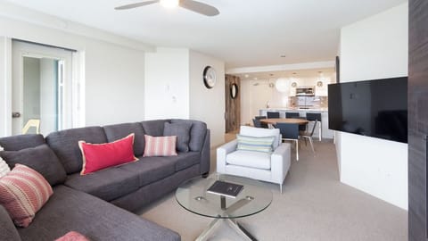 - Bright open living room with mountain views and modern cozy seating  
- Relax after skiing by the fireplace or watch a movie on the flat-screen TV  
- Spacious layout connects living dining and kitchen for easy entertaining  