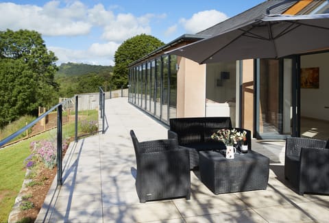 A staggering 16 metres of bi-folding doors opening out to a tiled balcony overlooking the beautiful river