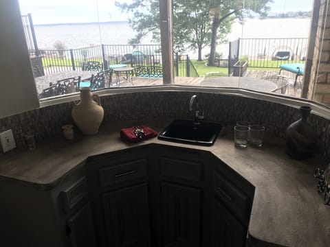 The  wet bar overlooks the deck and the panoramic view beyond.