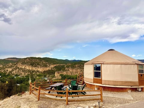 Yurt 7 at East Zion Resort with outdoor sitting area, picnic table, gas fire pit, BBQ grill, overlooking the valley below.