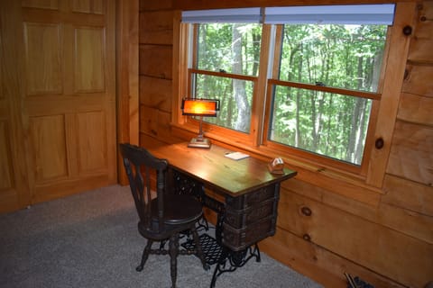 Antique Sewing Cabinet Writing Desk overlooks the woods.  Stationery provided.