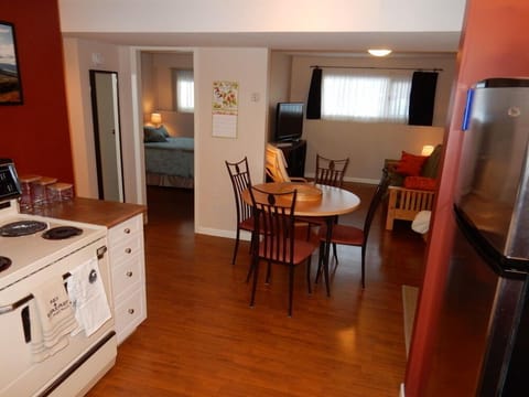 View from the kitchen into the living area with large screen tv