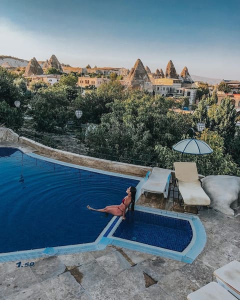 Seasonal outdoor pool, open 10:00 AM to 7:00 PM, pool umbrellas