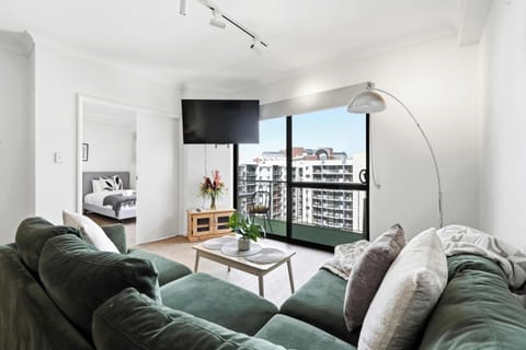 Modern comfort meets city views. Enjoy plush seating, a large Smart TV, a stylish coffee table, and a sun-filled living area that opens onto a private balcony.