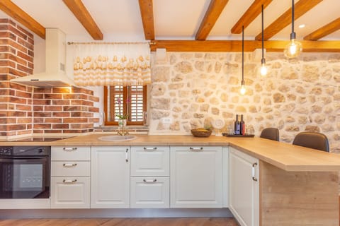 Traditional House (2 Bedrooms) | Private kitchen | Full-size fridge, microwave, oven, stovetop