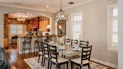 The dining room has a large dining table with seating for eight...