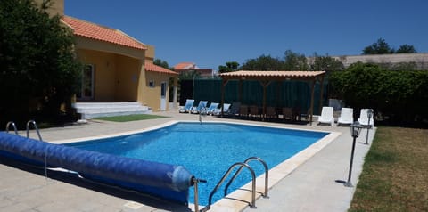 Swimming pool with Gazebo & tennis court in background