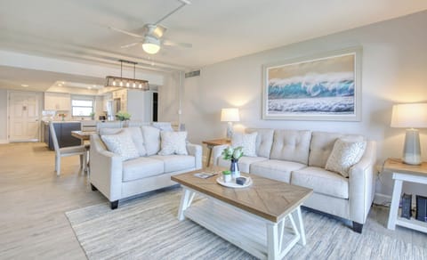 Bright and inviting living room with neutral tones and coastal artwork.