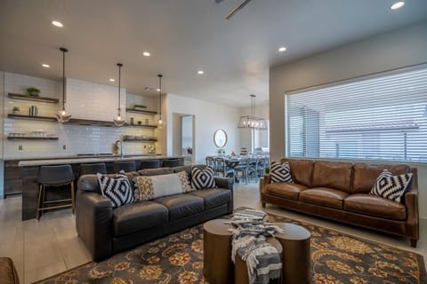 Main floor living room with a PS4, fireplace, and comfortable sofas
