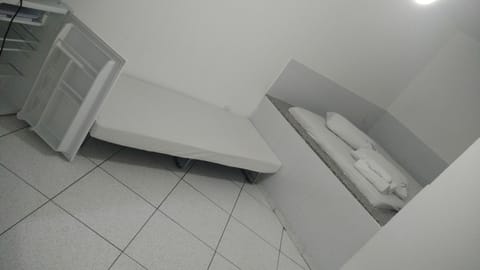 Economy Triple Room | Minibar, blackout drapes, bed sheets