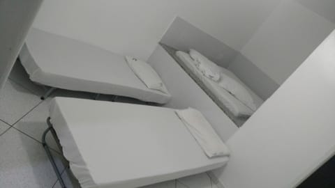 Economy Quadruple Room | Minibar, blackout drapes, bed sheets