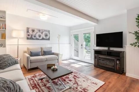 Relax in the light and bright living room with French doors that open wide onto the private deck