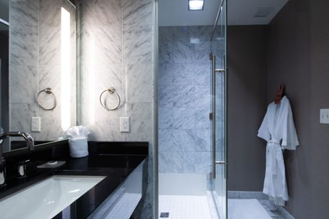 Shower, designer toiletries, hair dryer, bathrobes