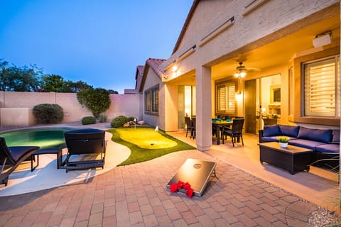A backyard full of entertainment! Corn hole Game, Putting Green, Heated Pool!