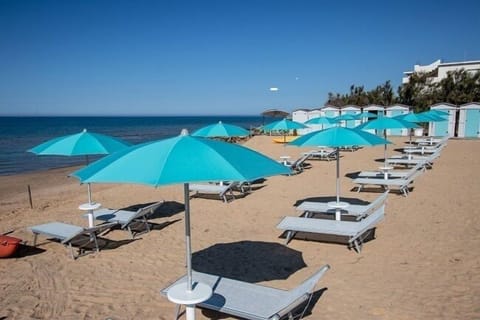 Private beach, white sand, sun loungers, beach umbrellas