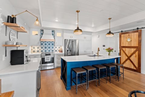 Decorative tile, GE cafe appliances, and sliding barn door are all features!