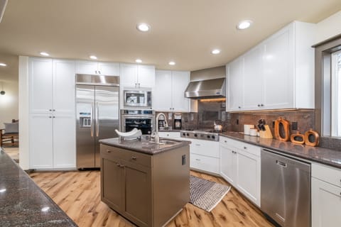 Remodeled kitchen with stainless steel appliances and granite countertops