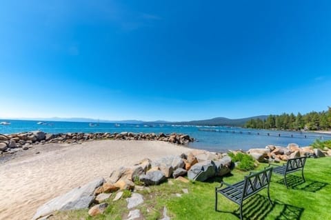 Enjoy the sunshine on the beach, just steps away from the condo, where the sky meets the tranquil waters