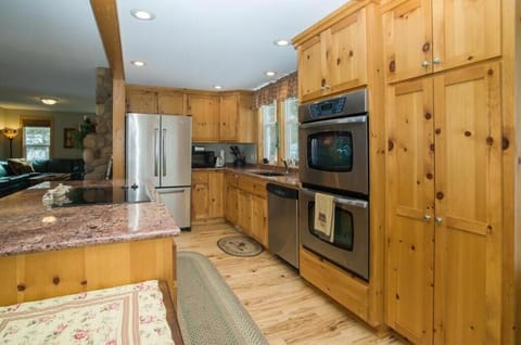 Kitchen is with a double oven, granite, stainless steel appliances