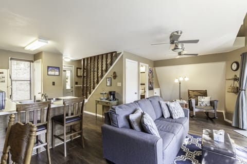 Living room area with sleeper sofa and mission style rocking chair.