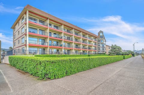 Multi-story property building with balconies and landscaped grounds provides a welcoming arrival experience.