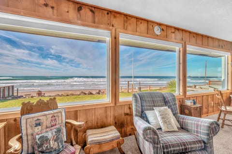 Wake up to breathtaking ocean waves through these panoramic windows in your cozy retreat.