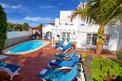 Stunning salt water heated pool and cushioned loungers at the sun terrace 