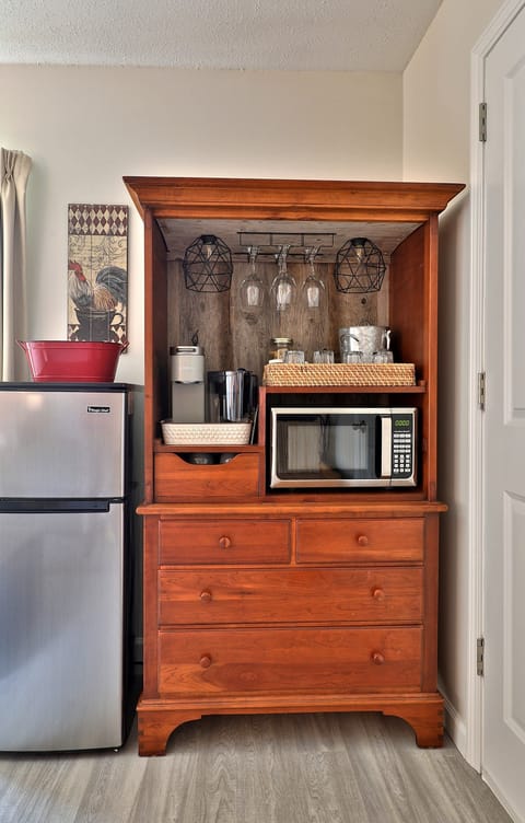 Mini fridge, microwave and hutch equipped with Keurig machine in queen suite adjoining room