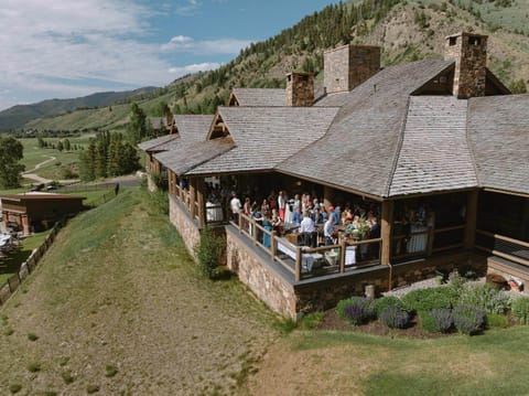 Timber-walled meeting cabin with a long boardroom table — one of several private event spaces on-site