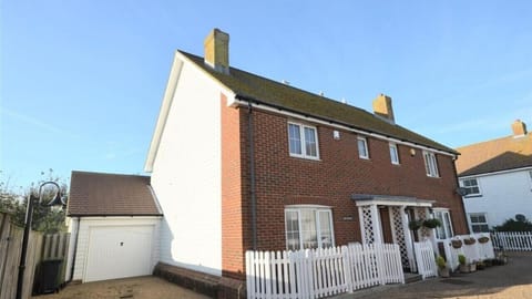 Front view with parking in front of house and garage
