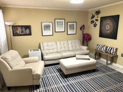 Wonderfully decorated living area with White leather furniture.
