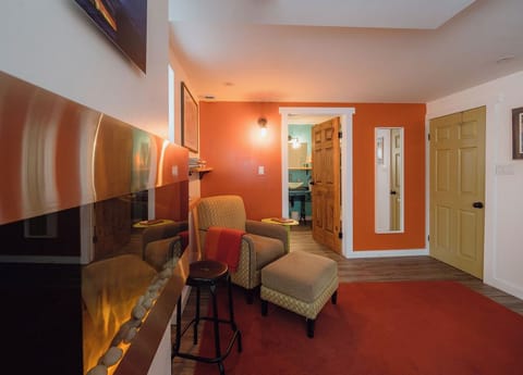 Inviting living space with warm orange accents and comfortable seating