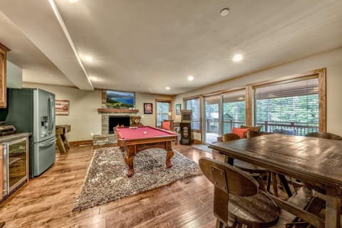 Spacious game room with pool table and scenic window views
