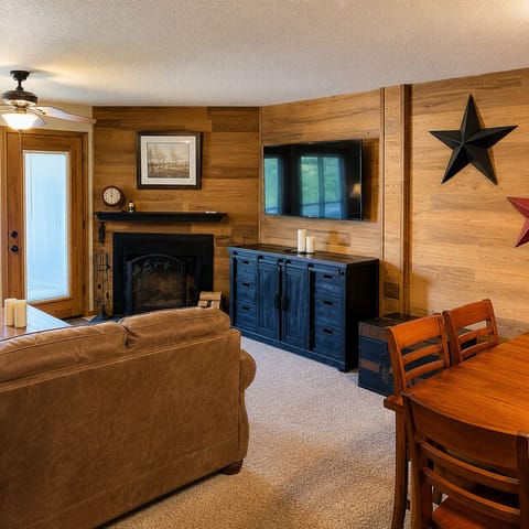 Cozy up in your rustic living space, where warm wood walls and a welcoming fireplace create the perfect retreat after mountain adventures.