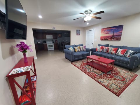 Living Room: personal desk, Sofabed, celing fan, wall mounted Smart TV