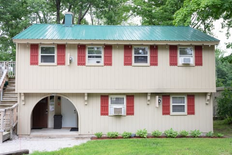 Front of home. Upstairs unit door is 2 under entry arch and is the door on the left