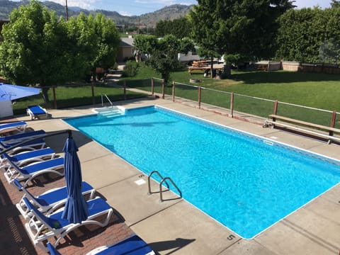Seasonal outdoor pool, open 10:00 AM to 8:00 PM, pool umbrellas