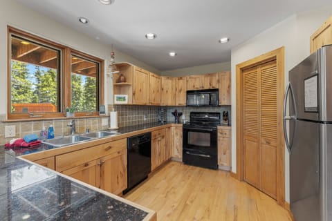 Plenty of counter room and cupboards are stocked with cooking utensils and serving supplies.