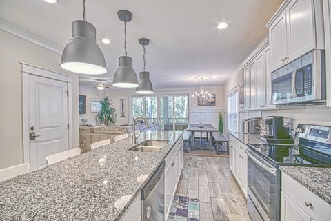 Luxury Kitchen & Dining Room overlooking living room. Huge Island with seating.