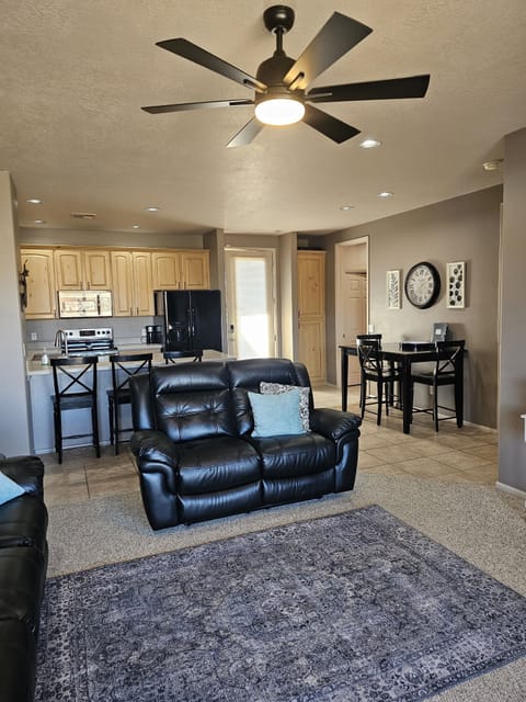 Living room looking into kitchen and front door