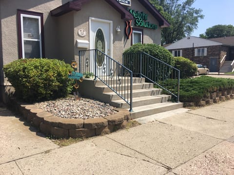 Front of house has business signage on the exterior. 