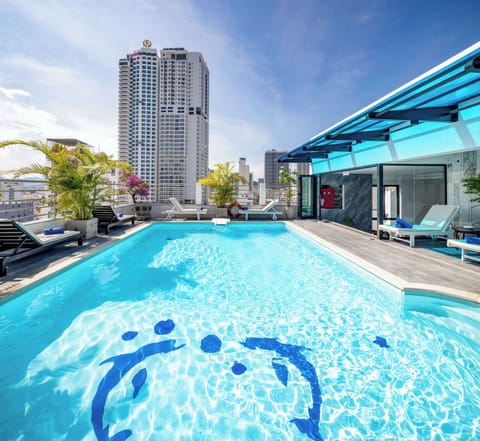 Outdoor pool, a rooftop pool, pool umbrellas, sun loungers