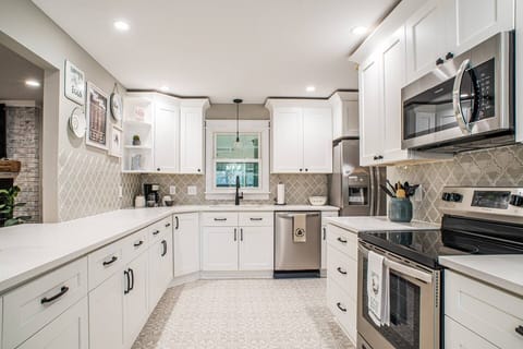 Stocked dream kitchen with loads of counter-space and cabinetry