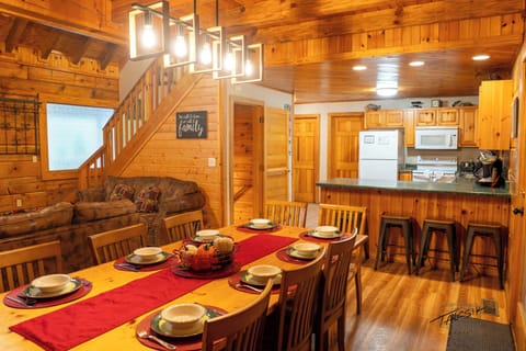 Open concept inviting dining room / fireplace, living room with vaulted ceiling