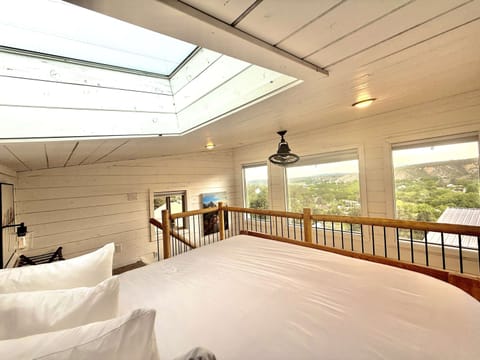 Enjoy stargazing from your plush king bed inside your East Zion Resort treehouse, a cozy and unique stay near Zion National Park and Bryce Canyon.